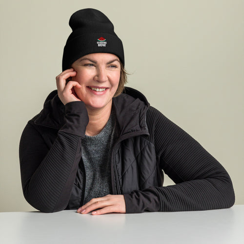 Model wearing the black embroidered Ceasefire Now beanie