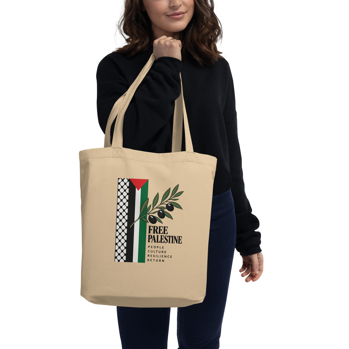 Model carrying the oyster Free Palestine tote bag, with the full front graphic visible